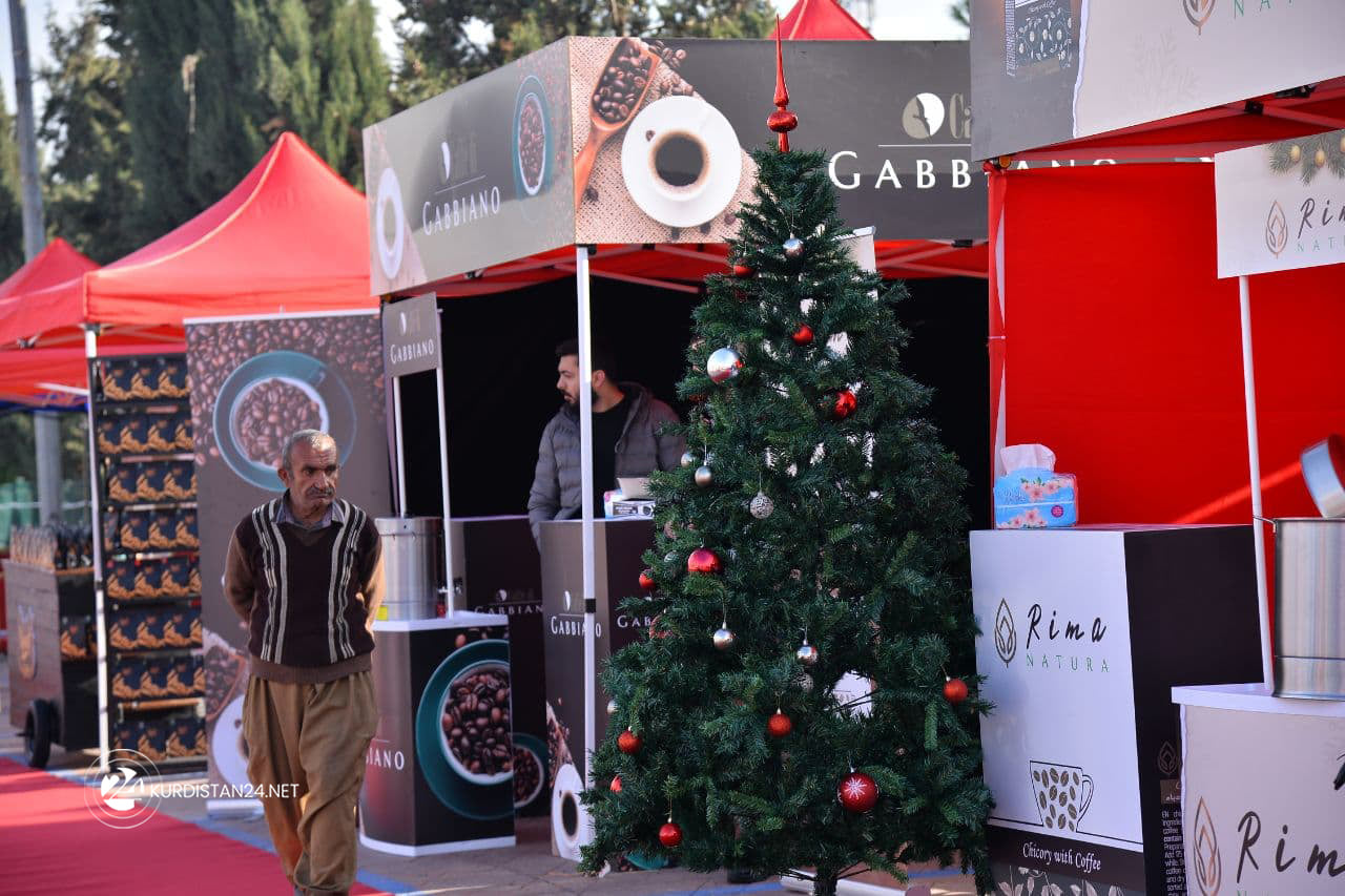A resident walks by a coffee pavilion at the exhibition, Dec. 29, 2021. (Photo: Rebaz Siyan/Kurdistan 24)